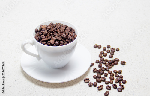 Preparation of coffee. Coffee beans in a white Cup.