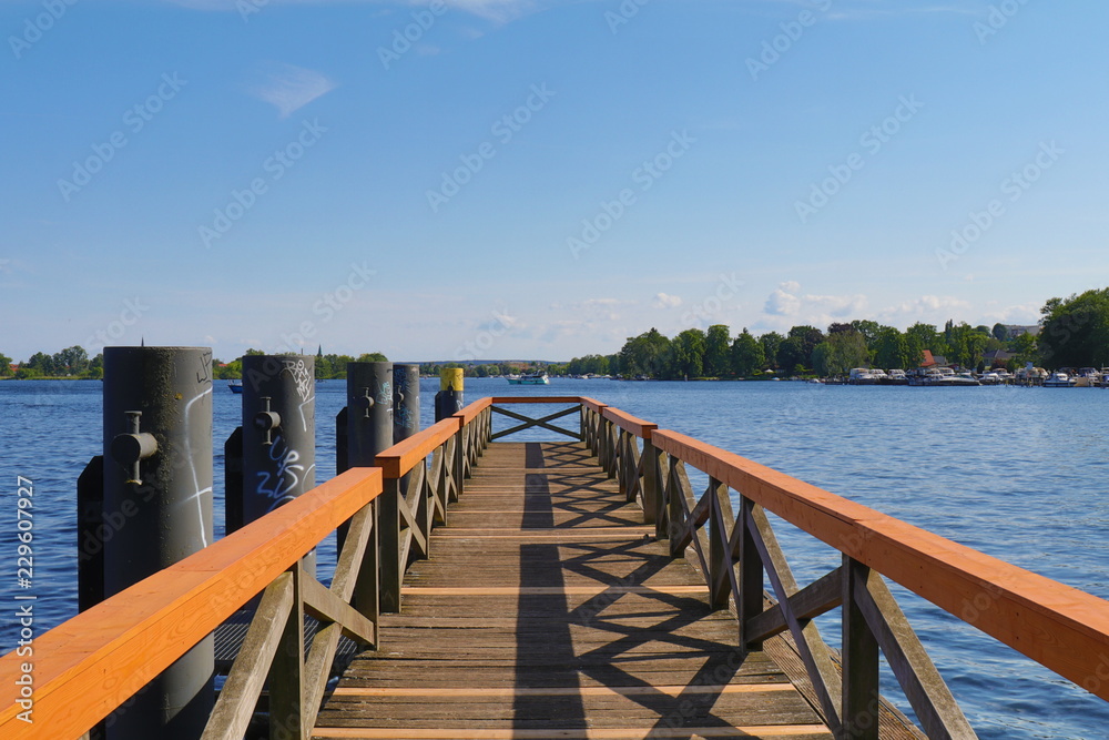 a wooden wharf on a lake