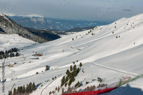 Dolomites, ski area with beautiful slopes. Empty ski slope in winter on a sunny day. Prepared piste and sunny day photo