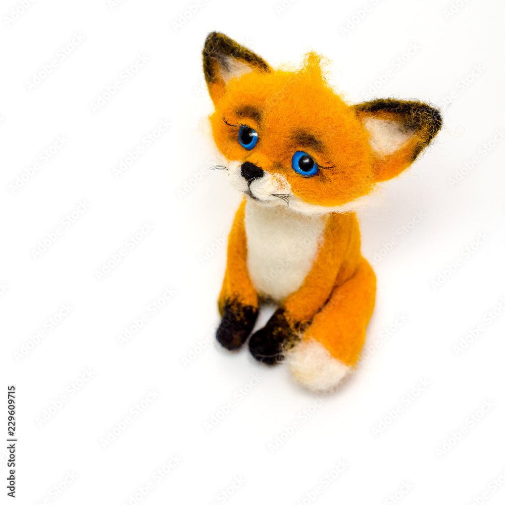 Felted toy cheerful red fox sitting