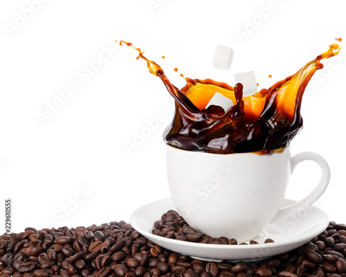 Throw sugar cube into coffee cup with splashing isolated on white background.