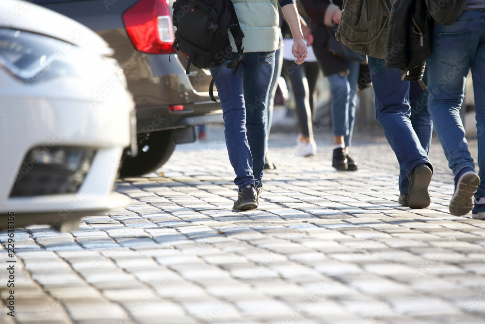 Obraz premium people cross the road in front of the car