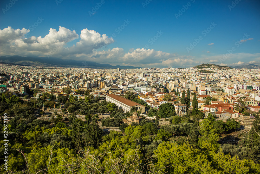 Scenery landscape of Athens - capital of Greece with view on mountain, houses and horizon line with blue sky with clouds from top of hill