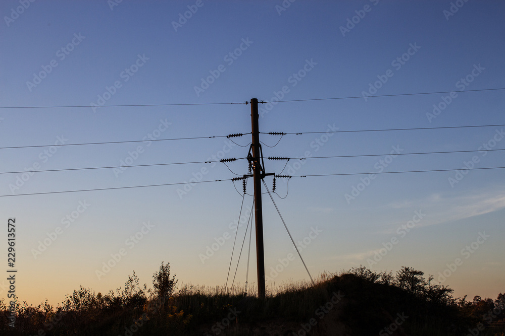 Power line against the evening sky. Copy space. Elements of the high-voltage line. Close-up.