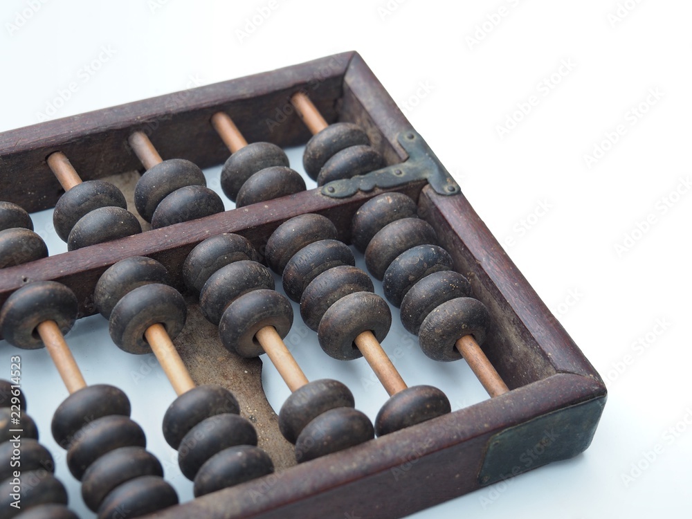 Old and ancient abacus made of wood and attached with a metal plate. On a white background It is a tool for calculating. This is China's first calculator. Old and ancient abacus made of wood and attached with a metal plate. On a white background It is a tool for calculating. This is China's first calculator.