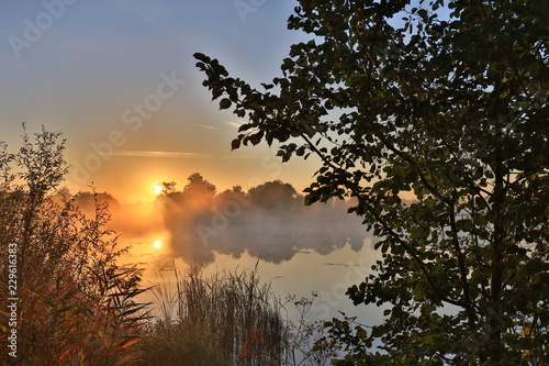 Early morning, sunrise over the lake. Rural landscape. HDR