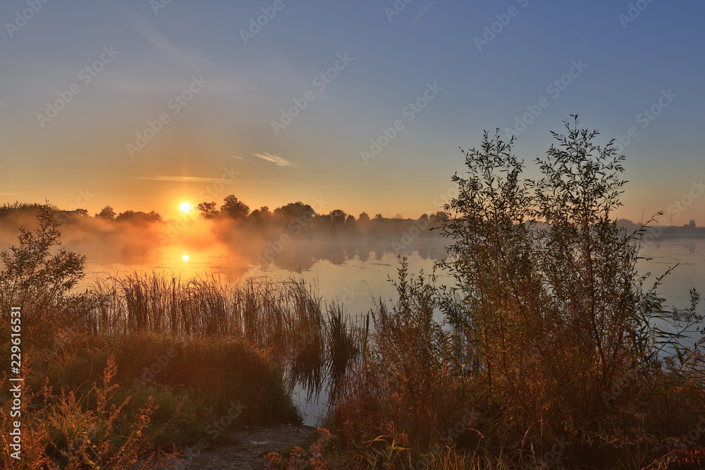 Naklejka premium Early morning, sunrise over lake. Rural landscape. HDR
