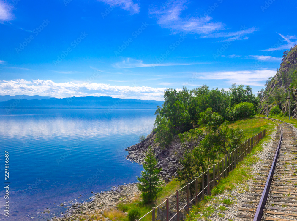 Bright summer landscape on the Circum-Baikal railway on the coast of Lake Baikal as a section of the Trans-Siberian Railway