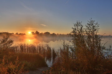 Early morning, sunrise over lake. Rural landscape. HDR