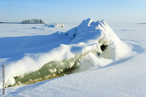 Winter landscape. Frozen lake with cracking ice. © ekim