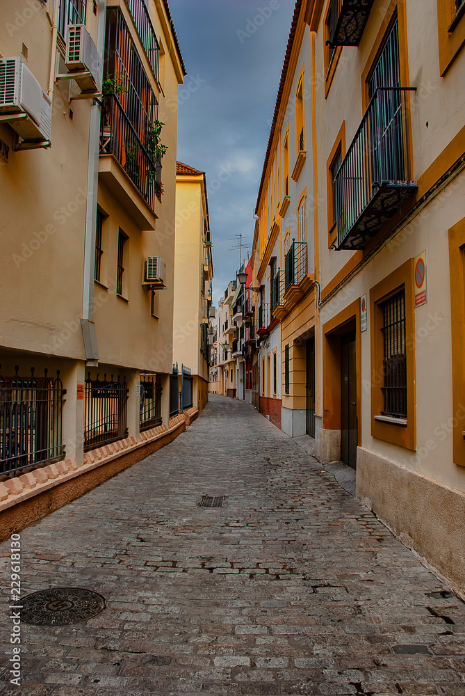 Building exteriors along the narrow streets of Seville, Spain