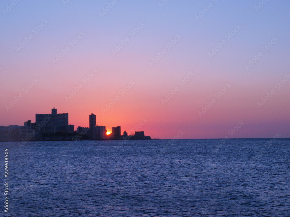Havana, Cuba - June 21, 2018: Spectacular sunset from the Havana Malecon, skyline with sun behind