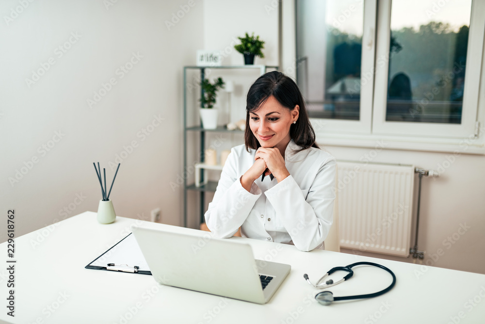 Female doctor working at office desk. Female doctor working at office desk.
