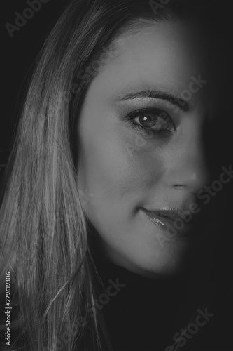 Beautiful woman emotional portrait in low light artistic conversion