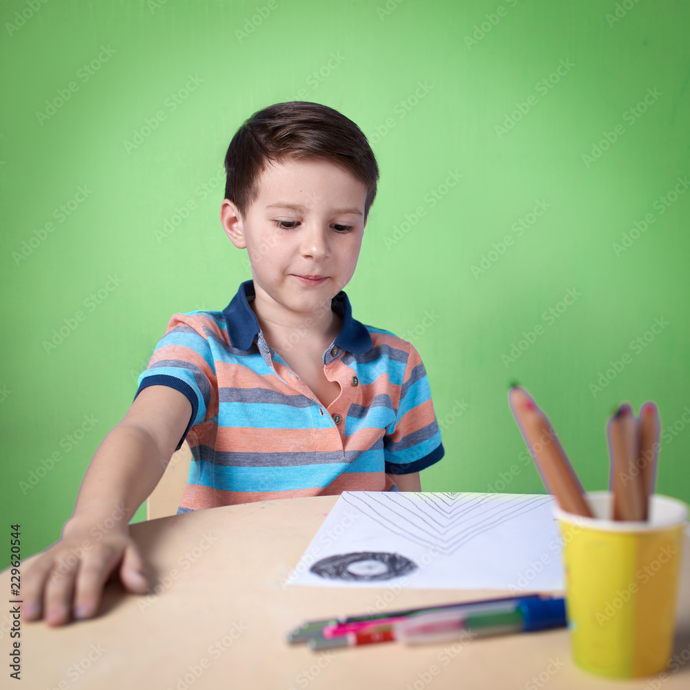 European boy spending time drawing with colorful pencils at home. European boy spending time drawing with colorful pencils at home.