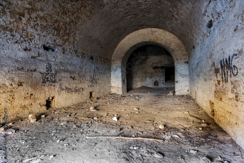 Old abandoned tunnel in the underground wine cellar. Entrance to the catacombs in Odessa, Ukraine. As a creative background for staged dark design