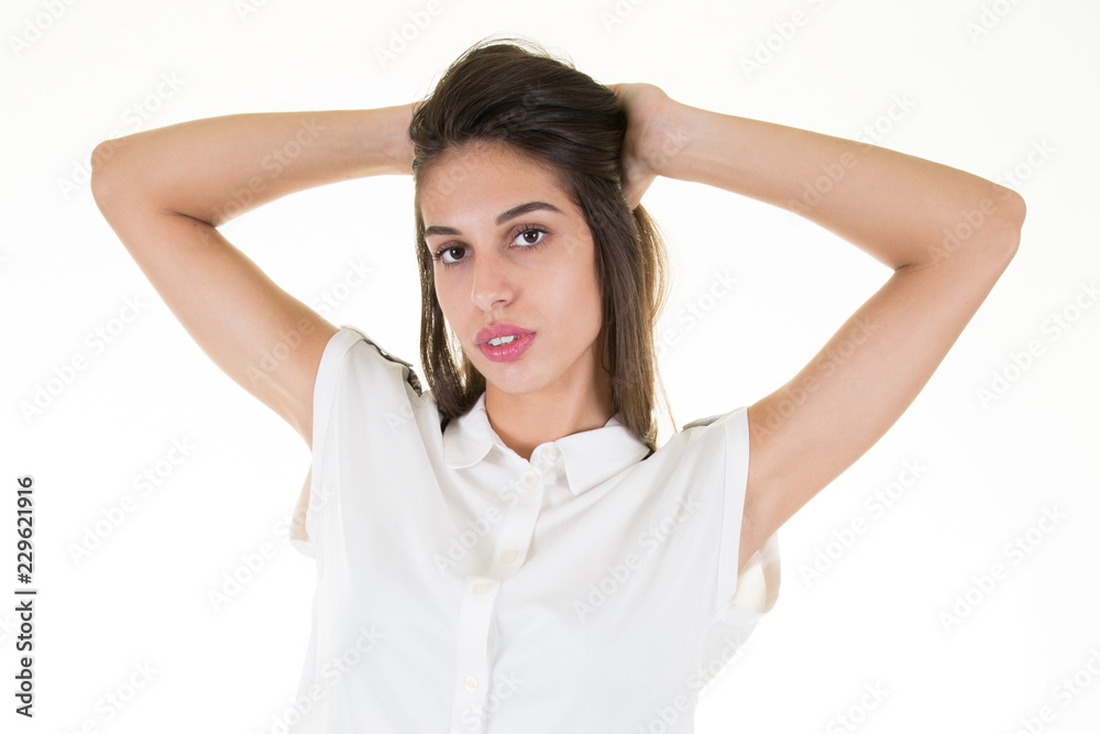 pretty woman in white blouse with hand behind her head pretty woman in white blouse with hand behind her head
