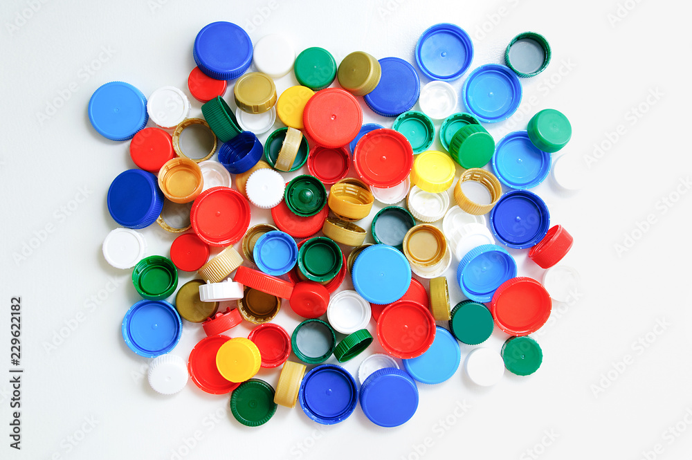 Plastic bottle caps on a white background. View from above. Plastic bottle caps on a white background. View from above.