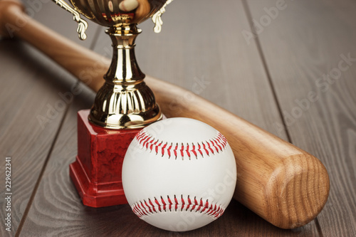 Photography golden trophy cup and baseball bat and ball on the wooden table