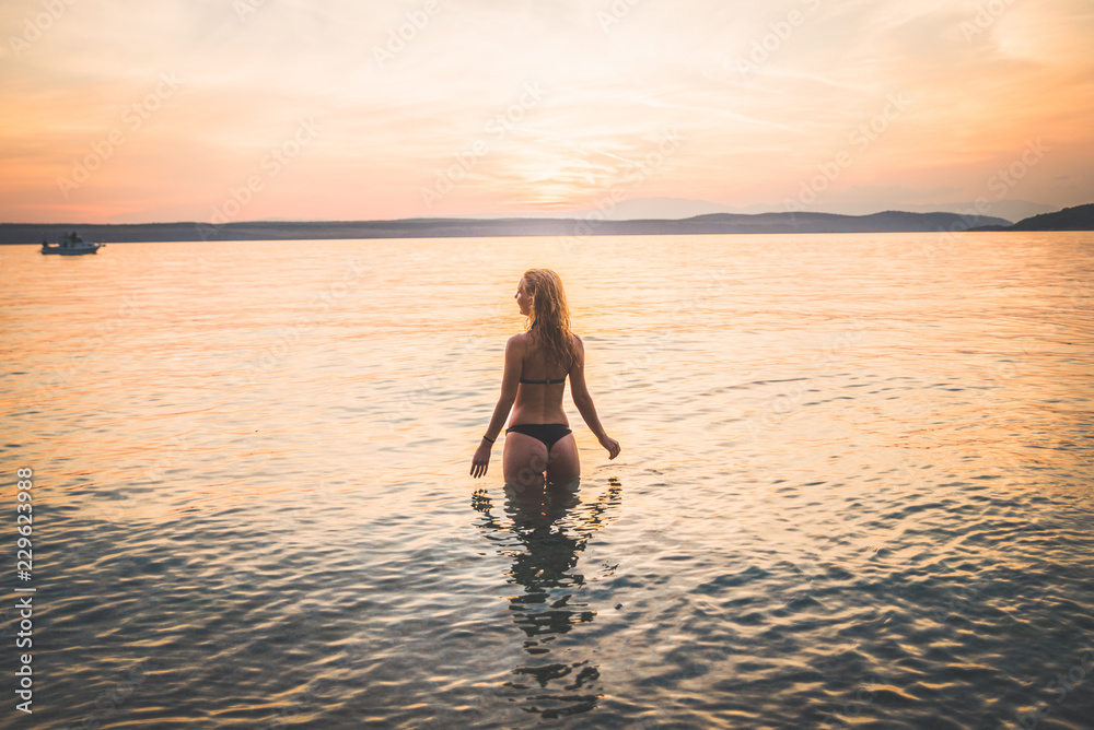 Young attractive girl model silhouette in the water