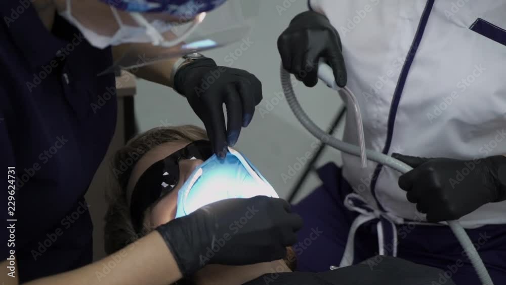 Dentist treating teeth to woman patient in clinic. Female professional doctor stomatologist at work. Dental check up in office Dentist treating teeth to woman patient in clinic. Female professional doctor stomatologist at work. Dental check up in office
