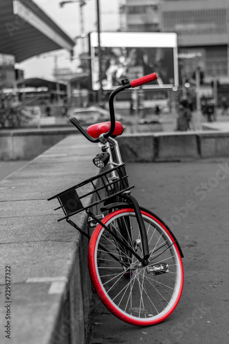 Vintage bike with orange wheels against the backdrop of the city