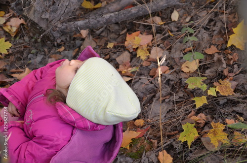 Happy little child. Child walking in warm jacket outdoor. Girl happy in pink coat enjoy fall nature park. Child wear fashionable coat with hood. Fall clothes and fashion concept. photo