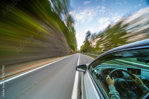 Car in motion blur driving in the Mountains