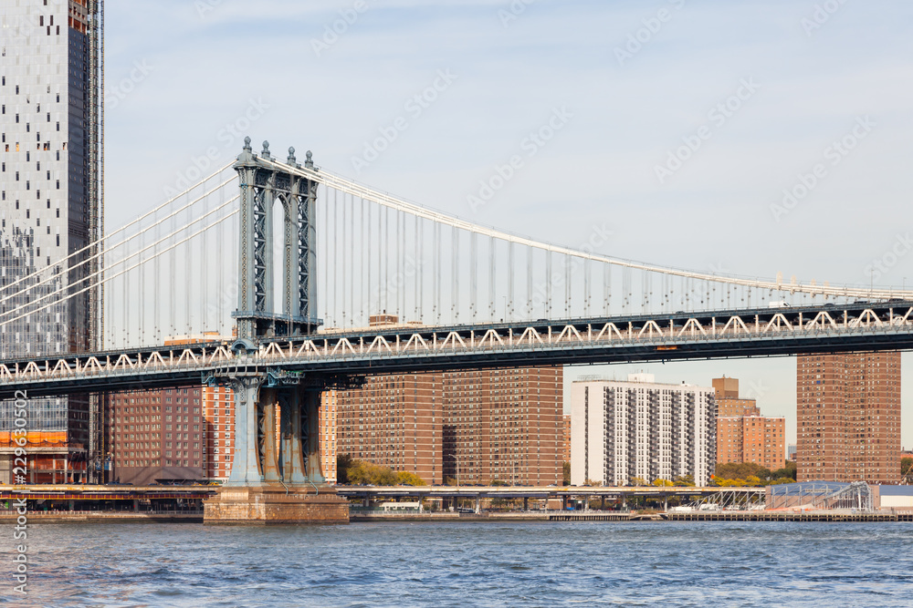Naklejka premium Manhattan Bridge. A view of Manhattan Bridge in New York City. The bridge spans the East River connecting the boroughs of Manhattan and Brooklyn.