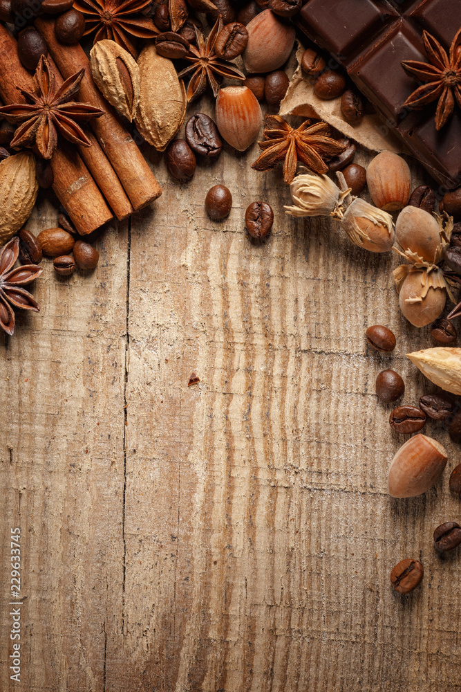 Texture spilling coffee beans, chocolate, cinnamon and cloves. Top view. Copy space. Texture spilling coffee beans, chocolate, cinnamon and cloves. Top view. Copy space.