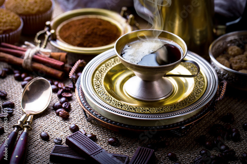 Black coffee in a cup on old background