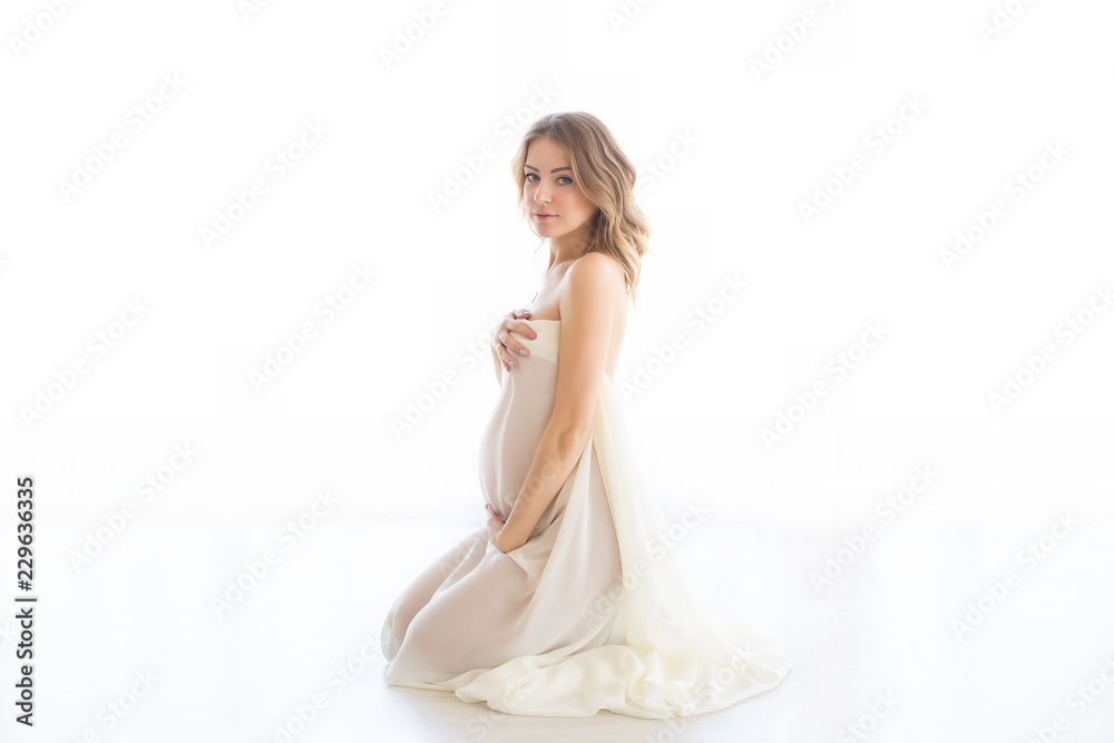 pregnant girl. pregnant on a light background. pregnant in lingerie.. a pregnant woman in the fabric pregnant girl. pregnant on a light background. pregnant in lingerie.. a pregnant woman in the fabric