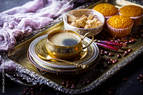 Black coffee in a cup on old background