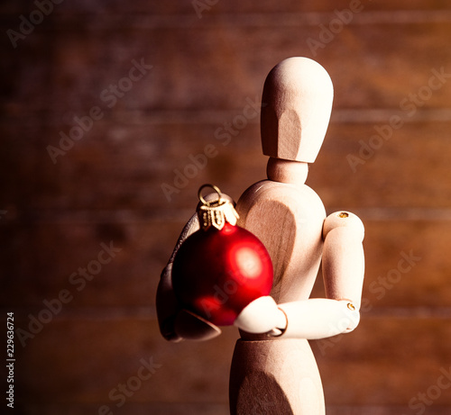 photo of the beautiful gestalta with red bauble on the brown wooden background photo