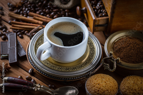 Black coffee in a cup on old background