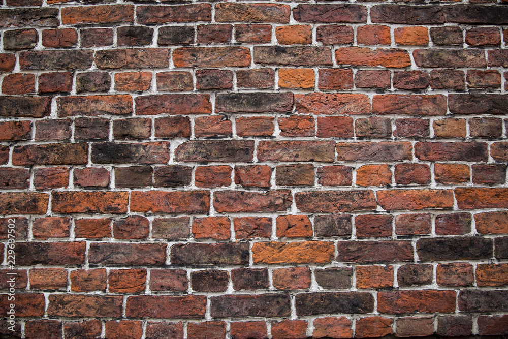 Obraz premium red (orange) brick wall background, horizontal wide brick wall.