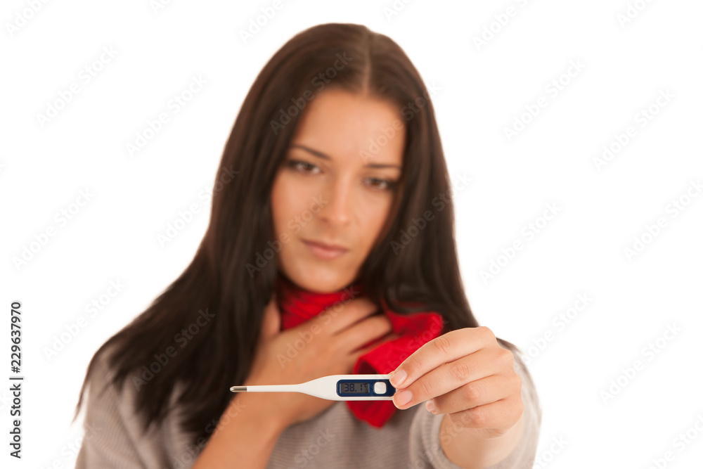 Ill woman has fever checking body temperature with thermometer isolated over white background Ill woman has fever checking body temperature with thermometer isolated over white background