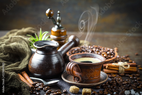 Black coffee in a cup on old background