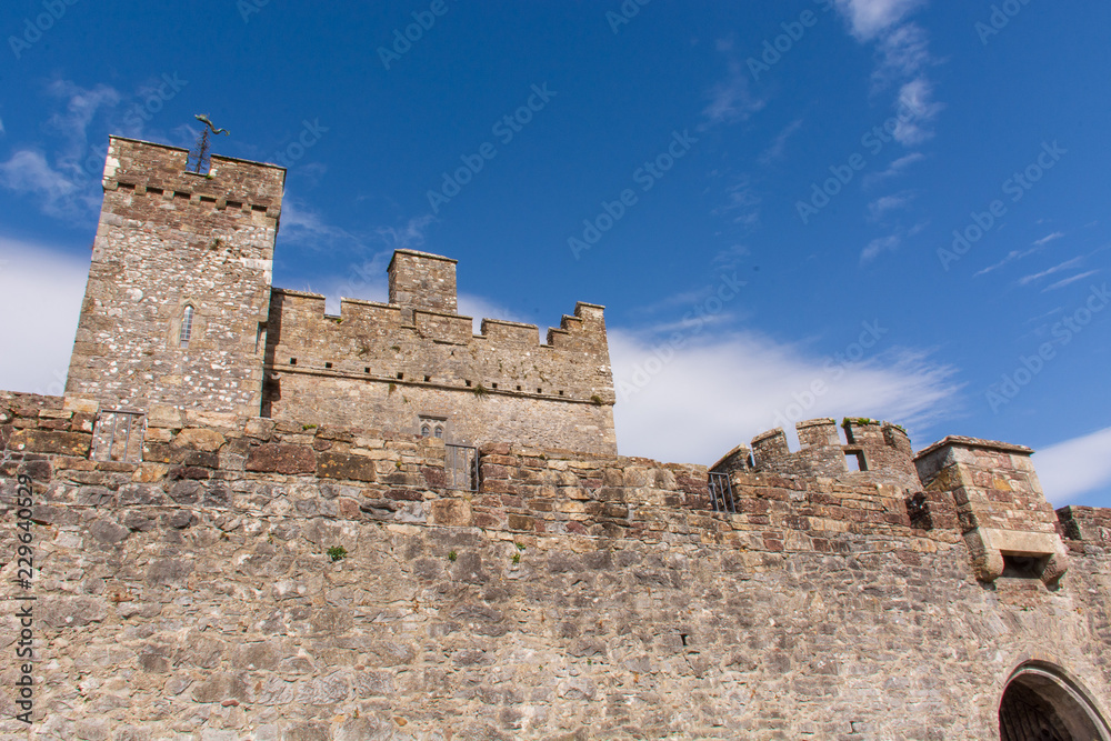 Stone castle tower profile against blue sky