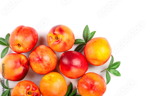 ripe nectarine with leaves isolated on white background with copy space for your text. Top view. Flat lay pattern