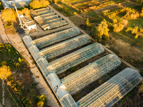 aerial view of glass agricultural greenhouses exterior on summer day f