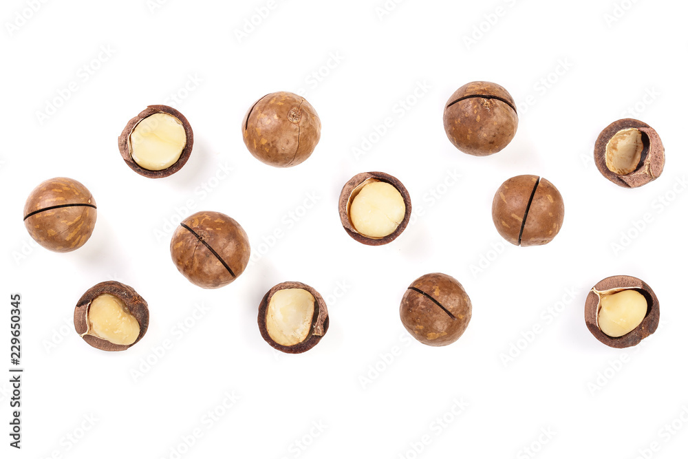 Shelled and unshelled macadamia nuts isolated on white background with copy space for your text. Top view. Flat lay pattern