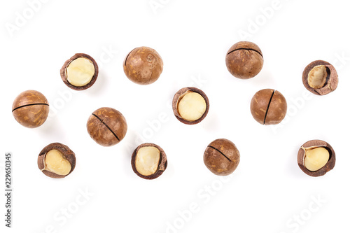 Shelled and unshelled macadamia nuts isolated on white background with copy space for your text. Top view. Flat lay pattern