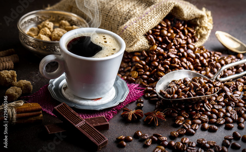 Black coffee in a cup on old background