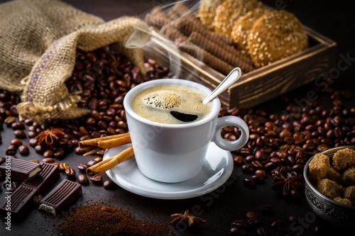 Black coffee in a cup on old background