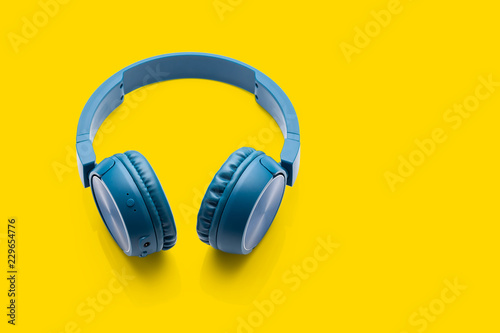 bluetooth blue headphone on yellow background