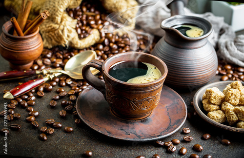 Black coffee in a cup on old background