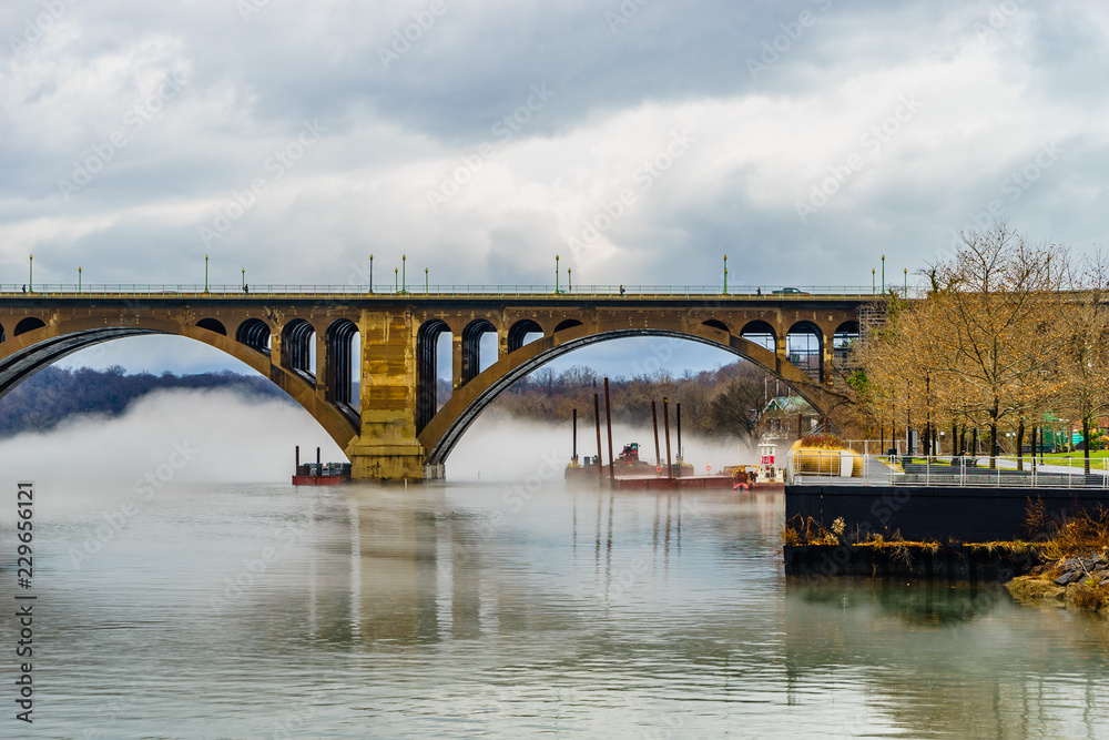 Francis Scott Key Bridge across Potomac River, winter fog on the water.