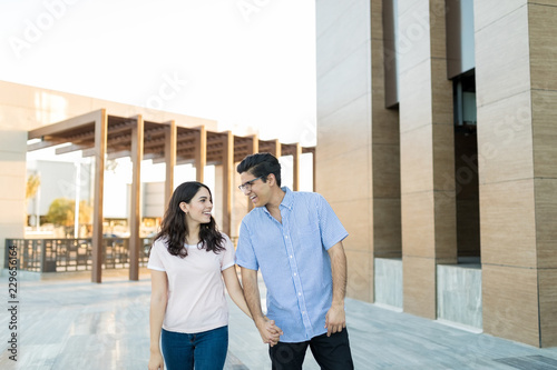 Cheerful Loving Couple Strolling Outside Shopping Mall