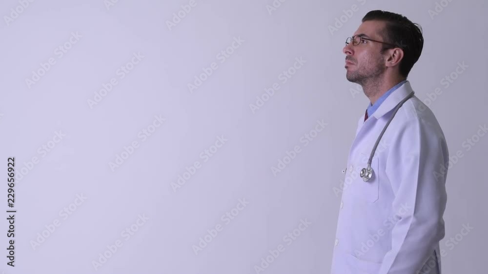 Profile view of young Hispanic man doctor